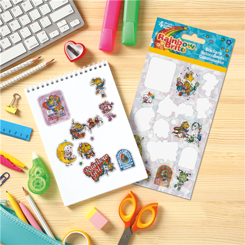 Sticker book and sheet with Rainbow Brite stickers on a desk with stationery items.