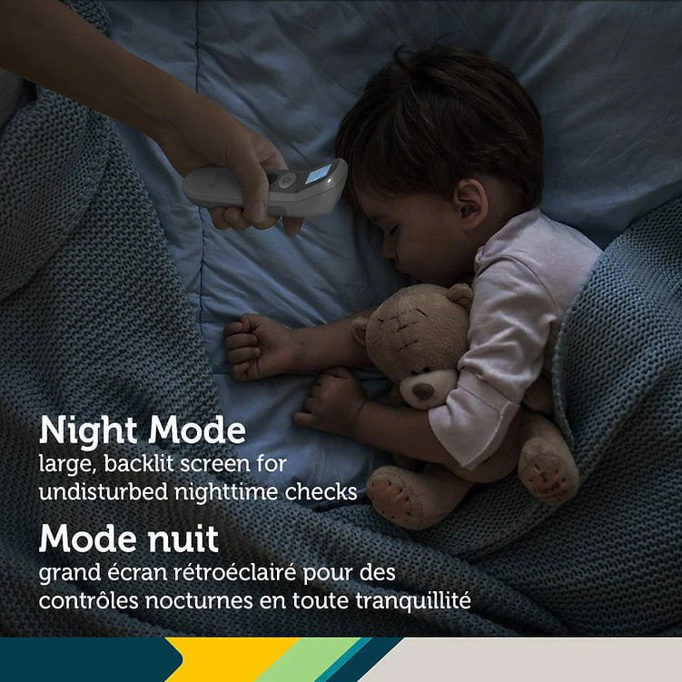 Child lying in bed with a teddy bear, being monitored by a device with text about night mode.