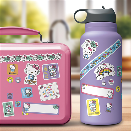 Pink lunch box and purple water bottle with Hello Kitty stickers on a blurred background
