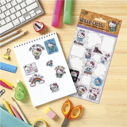 Hello Kitty stickers on a notebook with stationery items on a wooden surface