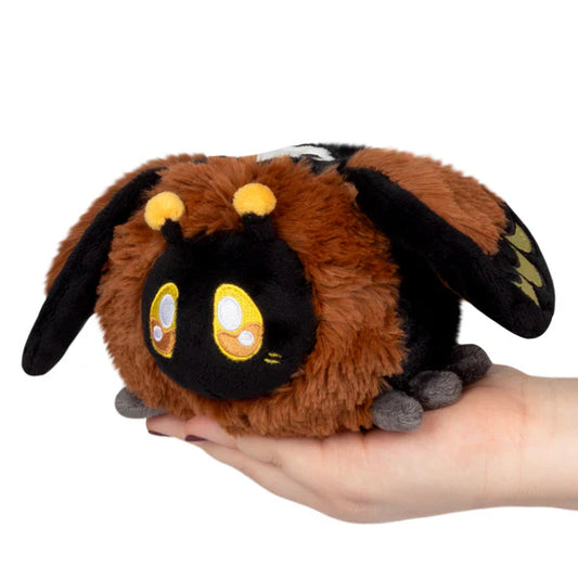 Squishable Snackers Death's-head Hawkmoth Plush toy resembling a dragon held in a hand on a white background