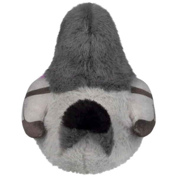 Squishable Snacker Pigeon S1E4 plush resting in hands, featuring soft grey fur, a bright purple and teal neck band, and little orange feet.