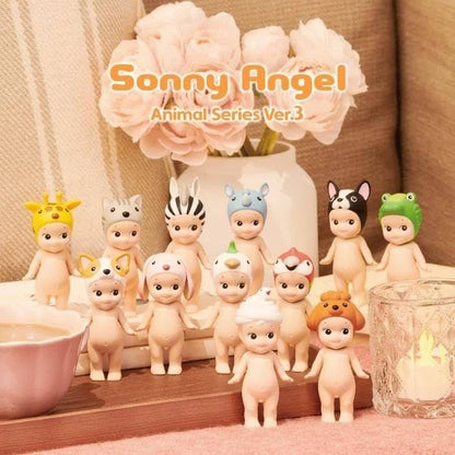 Collection of Sonny Angel figurines with decorative items on a table.