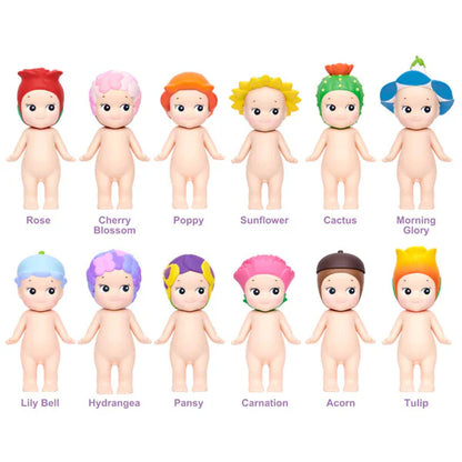 Set of 12 dolls with colorful hair on a white background, each labeled with a different color name.