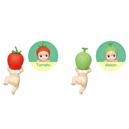 Two figurines with tomato and melon on their heads, labeled 'Tomato' and 'Melon', on a white background.