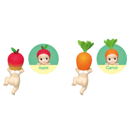 Two figurines, one resembling an apple and the other a carrot, with baby faces on a white background.