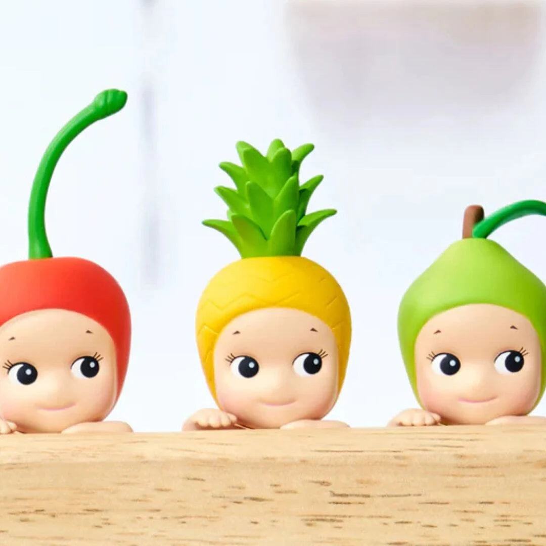 Sonny Angel Hippers Harvest Series mystery blind box mini figure featuring cherub characters in a climbing pose wearing fruit and vegetable headgear.