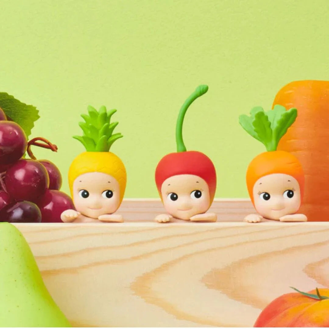 Sonny Angel Hippers Harvest Series mystery blind box mini figure featuring cherub characters in a climbing pose wearing fruit and vegetable headgear.