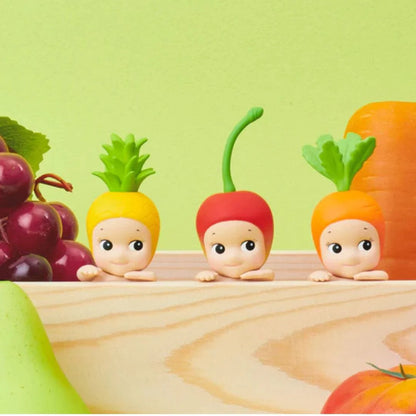 Sonny Angel Hippers Harvest Series mystery blind box mini figure featuring cherub characters in a climbing pose wearing fruit and vegetable headgear.