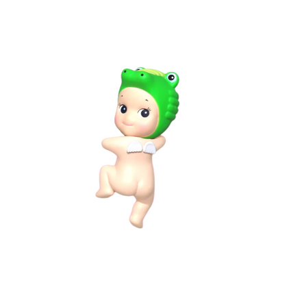 Toy figure of a baby with a green alligator cap on a white background