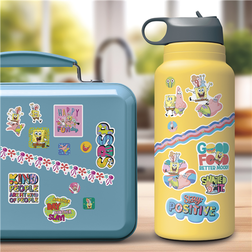 Blue lunch box and yellow water bottle with colorful graphics on a blurred background