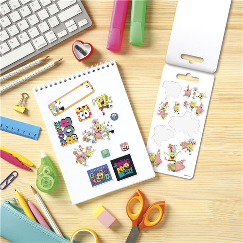 Colorful stickers on a notebook with stationery items on a wooden surface