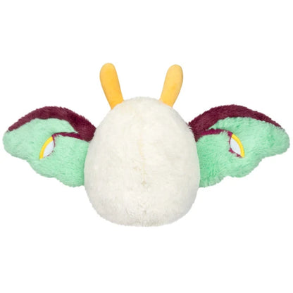 Squishable Alter Egos Series 21 Luna Mothman plush with cream fur, yellow antennae, burgundy feet, and mint green wings.