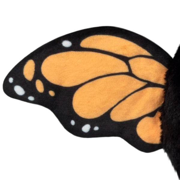 Squishable Alter Egos Series 21 Monarch Mothman plush with black fur, orange glowing eyes, a leaf accent, and monarch butterfly wings.