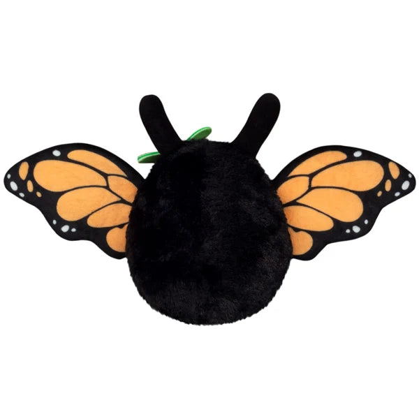 Squishable Alter Egos Series 21 Monarch Mothman plush with black fur, orange glowing eyes, a leaf accent, and monarch butterfly wings.