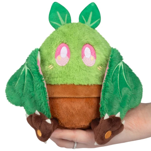 Squishable Alter Egos Series 21 Plant Mothman plush sitting in a plush brown flowerpot with bright green fur, leafy antennae, and leafy wings.