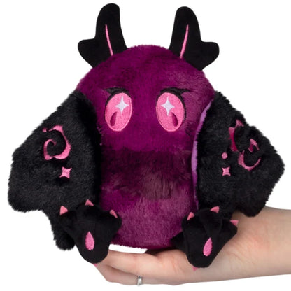Squishable Alter Egos Series 21 Poison Mothman plush featuring deep magenta fur, glowing pink eyes, and black wings with pink embroidery.