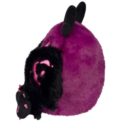 Squishable Alter Egos Series 21 Poison Mothman plush featuring deep magenta fur, glowing pink eyes, and black wings with pink embroidery.