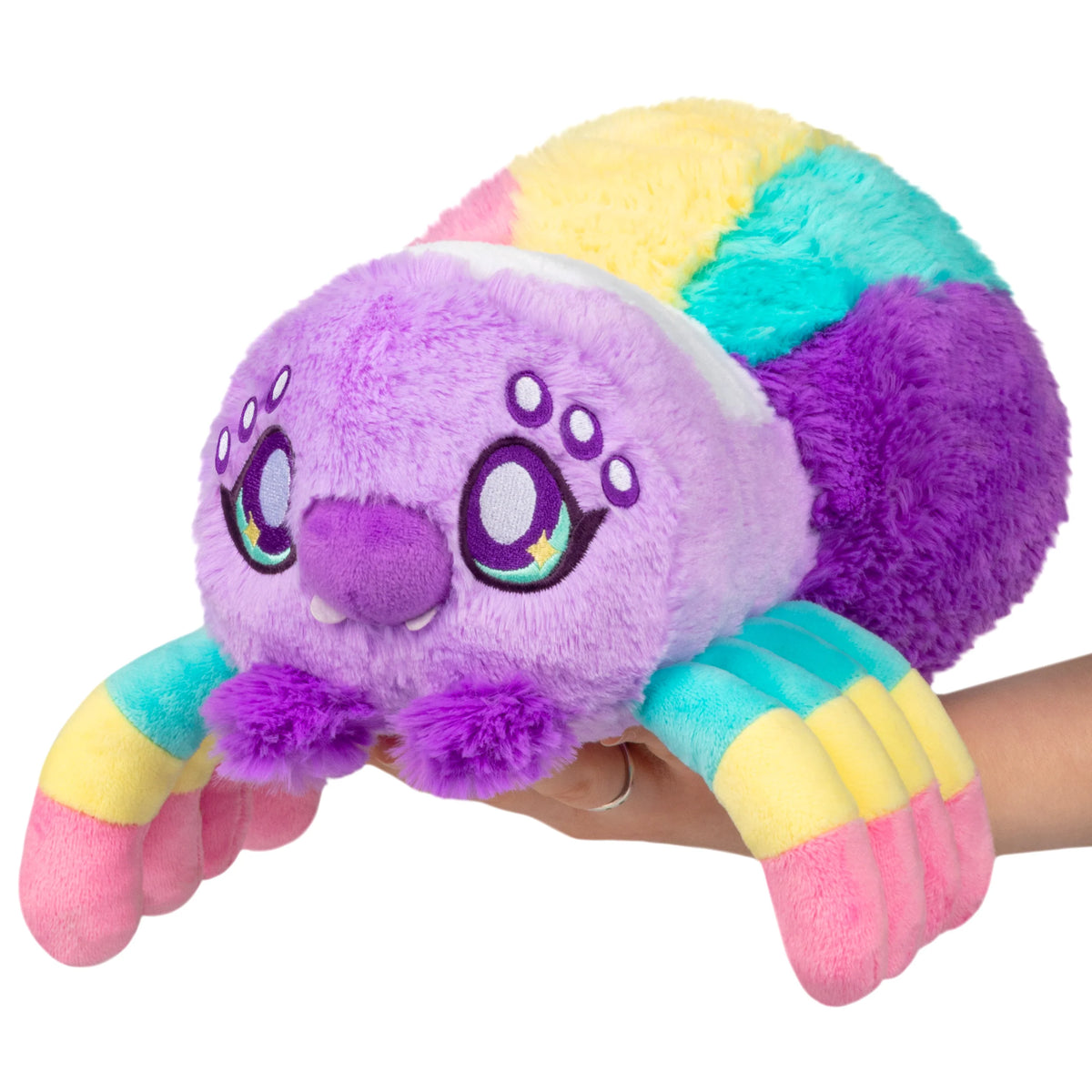 Squishable Mini Rainbow Spider plush with a colorful segmented body, eight striped legs, and big purple sparkling eyes.