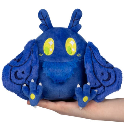 Squishable Snacker Blue Mothman S1E3 limited edition plush featuring deep blue fur, embroidered wings, and bright yellow eyes.