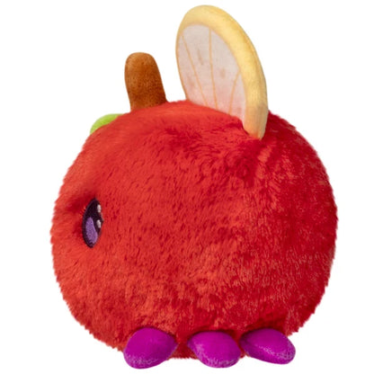 Squishable Snacker Fruit Fly S1E3 limited edition plush shaped like a red apple with citrus slice wings and purple feet.