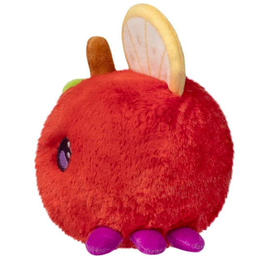 Squishable Snacker Fruit Fly S1E3 limited edition plush shaped like a red apple with citrus slice wings and purple feet.