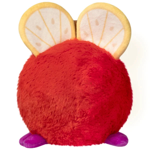 Squishable Snacker Fruit Fly S1E3 limited edition plush shaped like a red apple with citrus slice wings and purple feet.