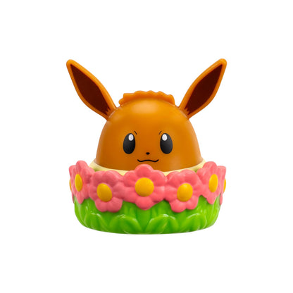Toy figure of a character with large ears and a flower-like base on a white background