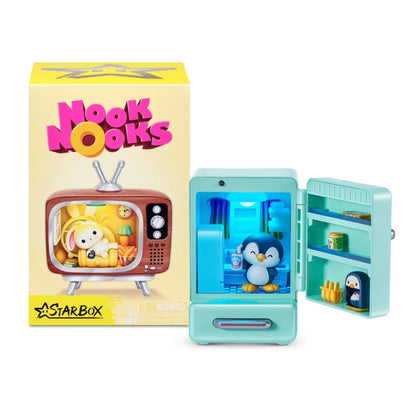 Teal toy refrigerator with penguin figure and 'Nook Nooks' packaging on a white background