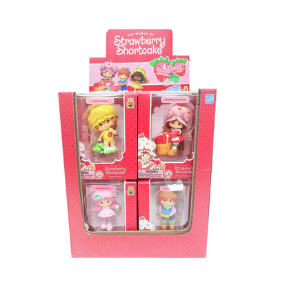 Strawberry Shortcake toy figures in a display box on a white background