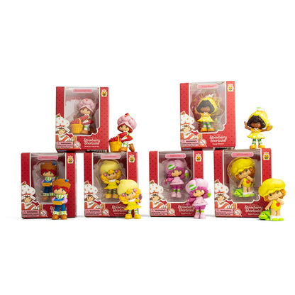 Set of Strawberry Shortcake figurines in various poses with packaging on a white background