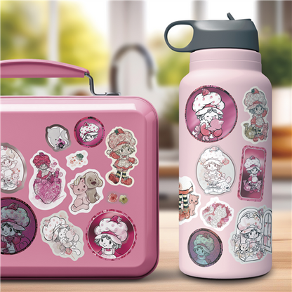 Pink lunch box and water bottle with character stickers on a blurred background