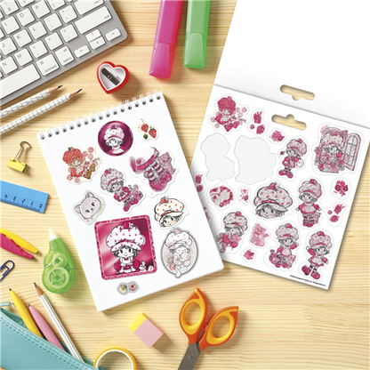 Sticker sheets with cartoon characters on a desk with stationery items