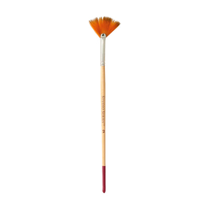 Paintbrush with orange bristles on a white background