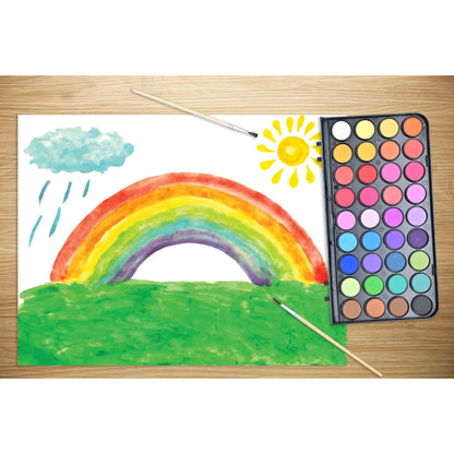 Child's drawing of a rainbow, cloud, and sun with a color palette and paintbrush on a wooden surface.