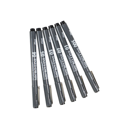 Studio Series 6-Piece Micro-Line Pen Set in a transparent reusable storage case, featuring six fine-line black pigment ink pens in various sizes.