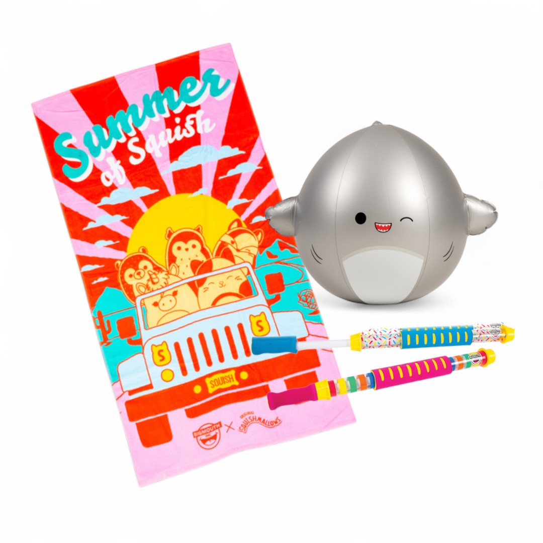 Colorful beach towel with a summer design, a small shark-shaped beach ball, and two water guns on a white background.