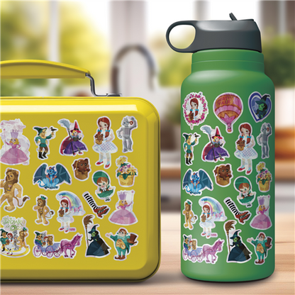 Yellow lunch box and green water bottle with cartoon character stickers on a blurred outdoor background