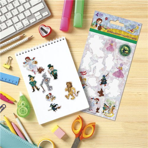 Sticker sheet with characters on a notebook and stationery items on a desk