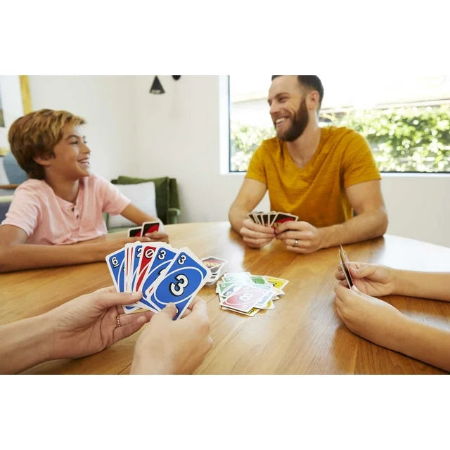 People playing cards together at a table in a casual setting
