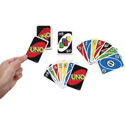 Hand holding UNO cards against a white background