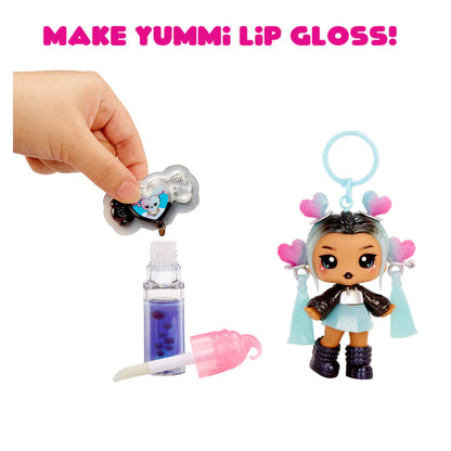 Make Yummi Lip Gloss set with a doll and lip gloss components on a white background.