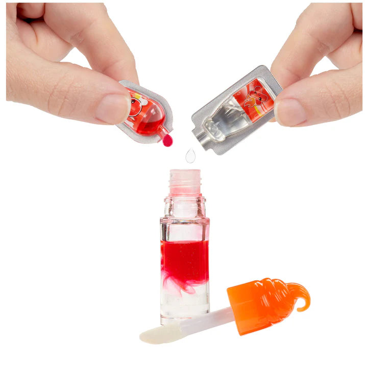 Hand holding a small bottle with red liquid and a dropper, with a white background.
