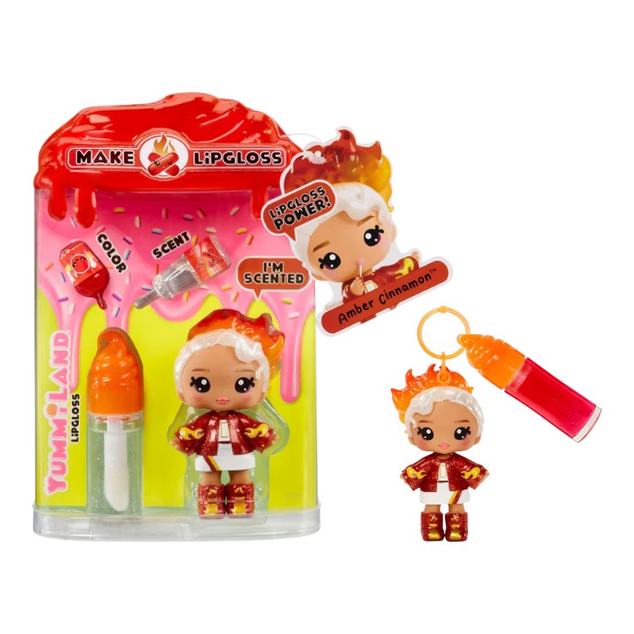 Product view of Yummiland Series 2 Amber Cinnamon doll with fiery red and white hair, alongside her DIY lip gloss kit including a custom bottle and mixing spoon.