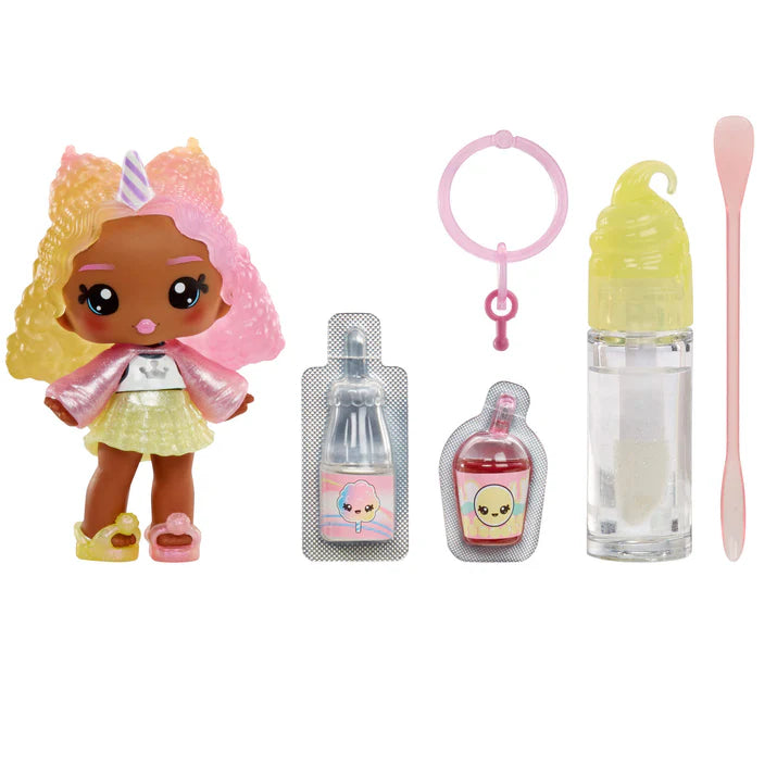 Product view of Yummiland Series 2 Nia Candy Fluff doll with pink and yellow hair, alongside her DIY lip gloss kit including a custom bottle and mixing spoon.