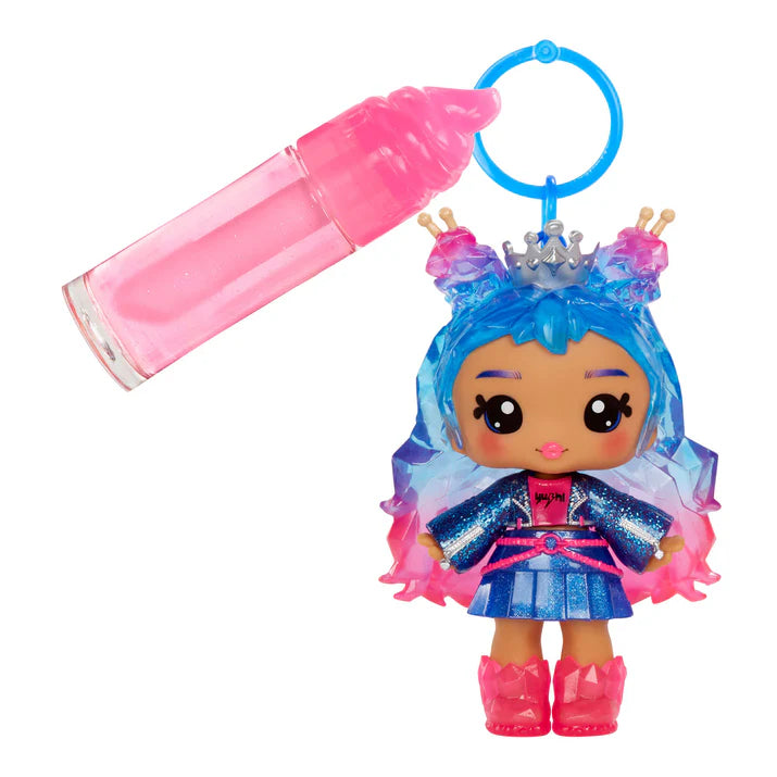Toy figure with blue hair and pink accessories next to a pink spray bottle on a white background