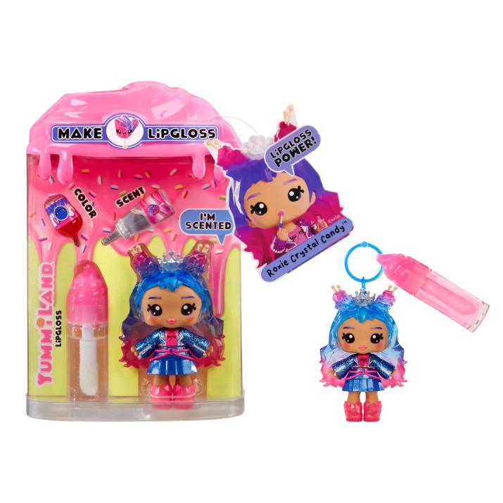 Product view of Yummiland Series 2 Roxie Crystal Candy doll with blue and purple hair, alongside her DIY lip gloss kit including a custom bottle and mixing spoon.