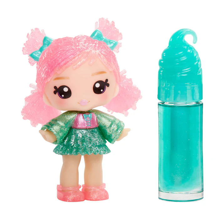 Toy doll with pink hair and green outfit next to a blue bottle on a white background